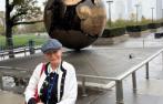 Professor Malgosia Fitzmaurice standing in front of the Sphere Within Sphere sculpture outside the UN offices in New York.