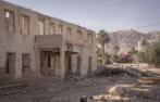 The destroyed abandoned building and the Mount of Temptation on the background at Palestinian city of Jericho at West Bank, Palestine.