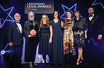 The qLegal team standing with their LexisNexis award, next to Sir Tony Robinson.