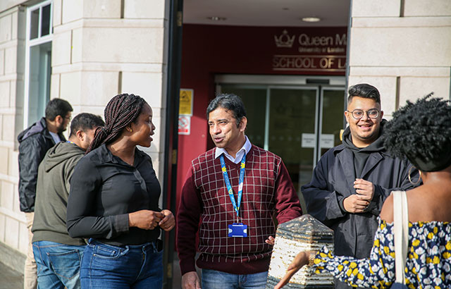 A group of Queen Mary postgraduate law students talking outside the Centre for Commercial Law Studies.