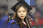 Yijia Lui wearing graduation gown and mortar board.