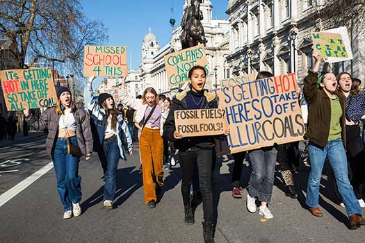 Protestors holding placards at a climate change protest.