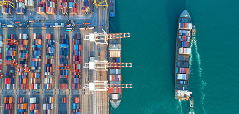 Commercial freight ship leaving a dock
