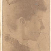 Sepia photograph of a woman in profile clothed in late 19th century dress