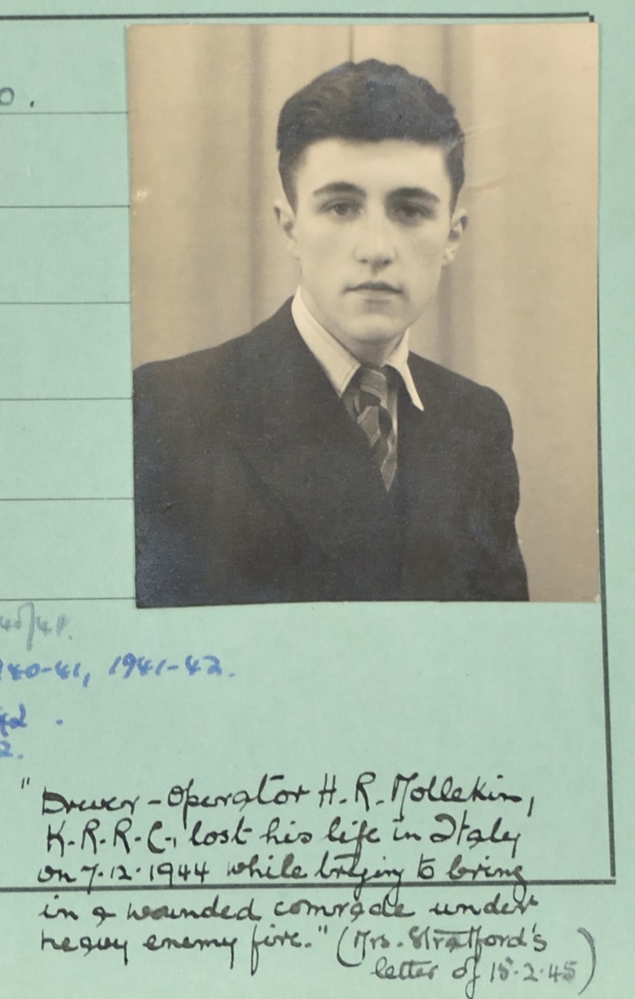 Photograph of young man in dark suit with handwritten description of his death below