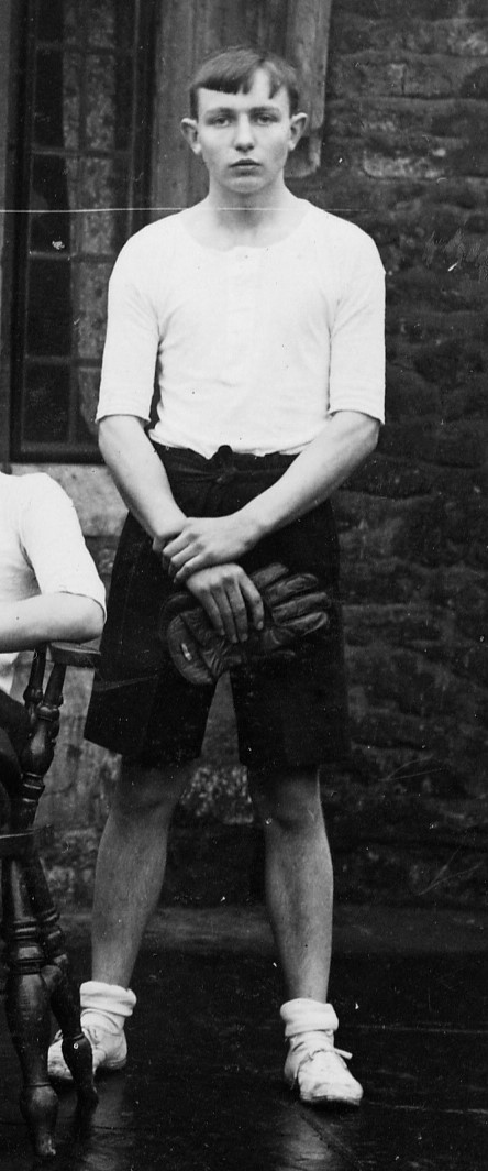 Boy standing holding a glove