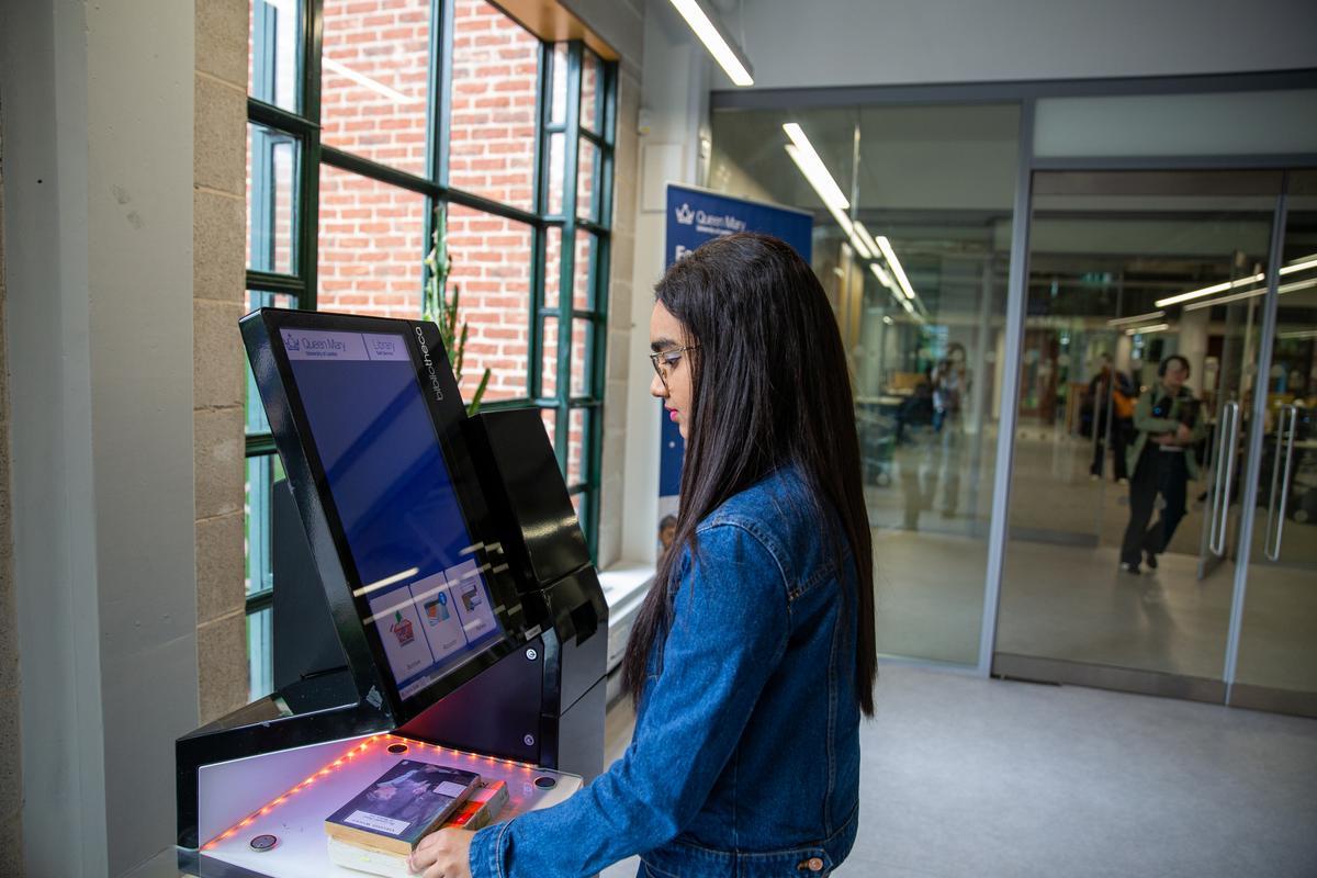 Student borrowing books using a self issue kiosk