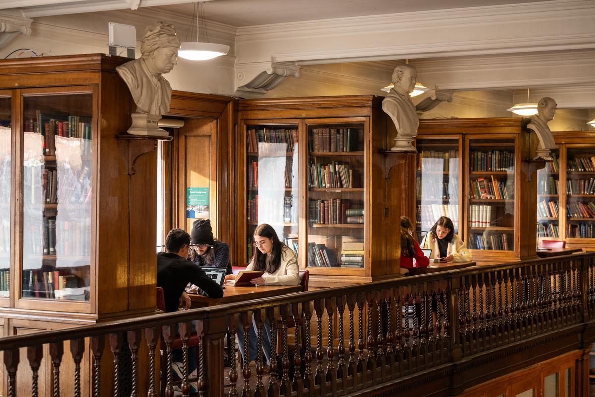 3 students studying together on a desk at West Smithfield Library
