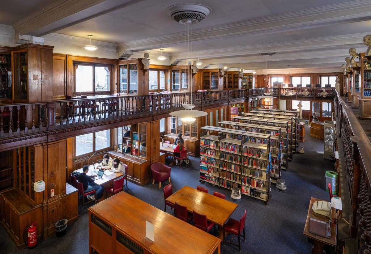 View of ground floor and mezzanine of West Smithfield Library showing study desks and book shelves