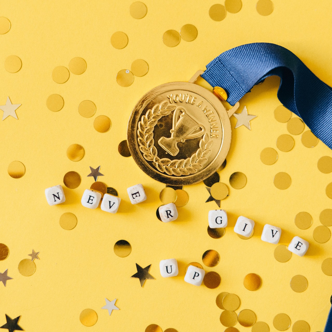 Medal and the words Never Give Up