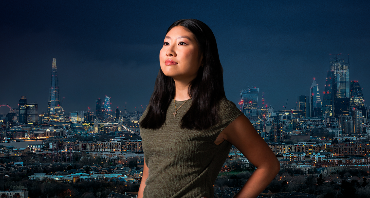 Image of a female student looking into the distance with night time London skyline in the background