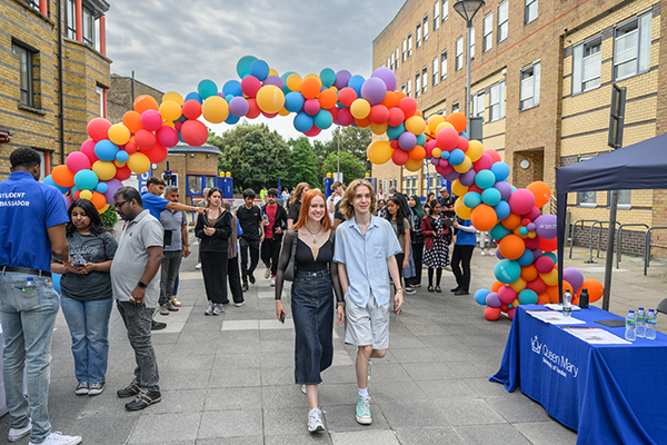 2 students in front of balloon arch at open day registration point