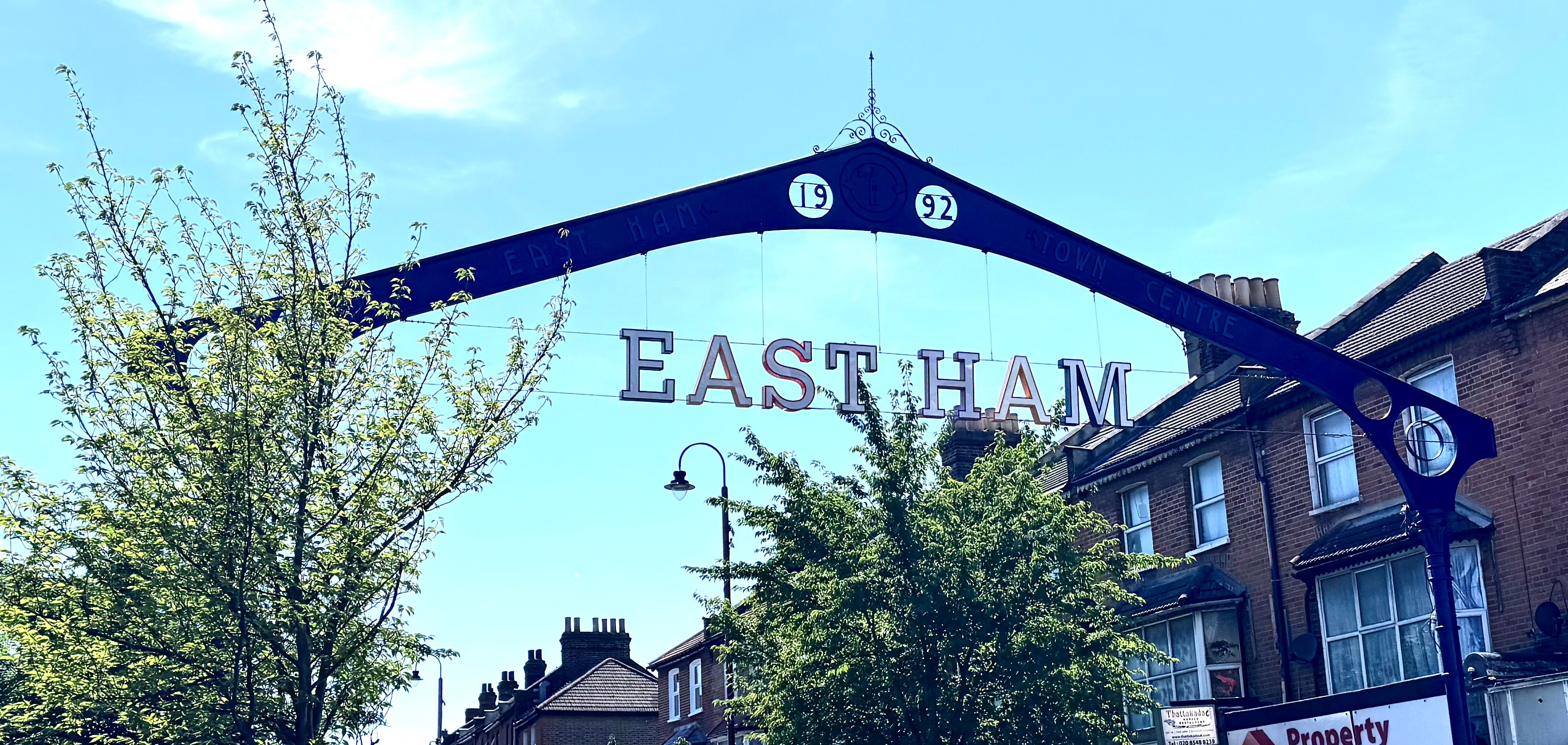 An arch over a high street reads 