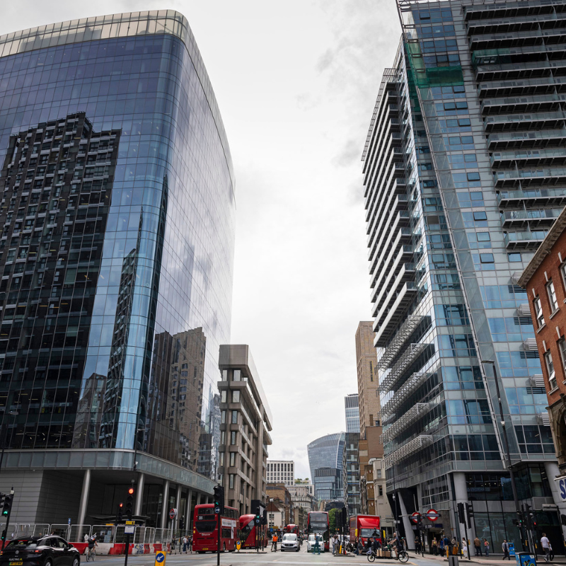 Two tall glass buildings on either side of a street