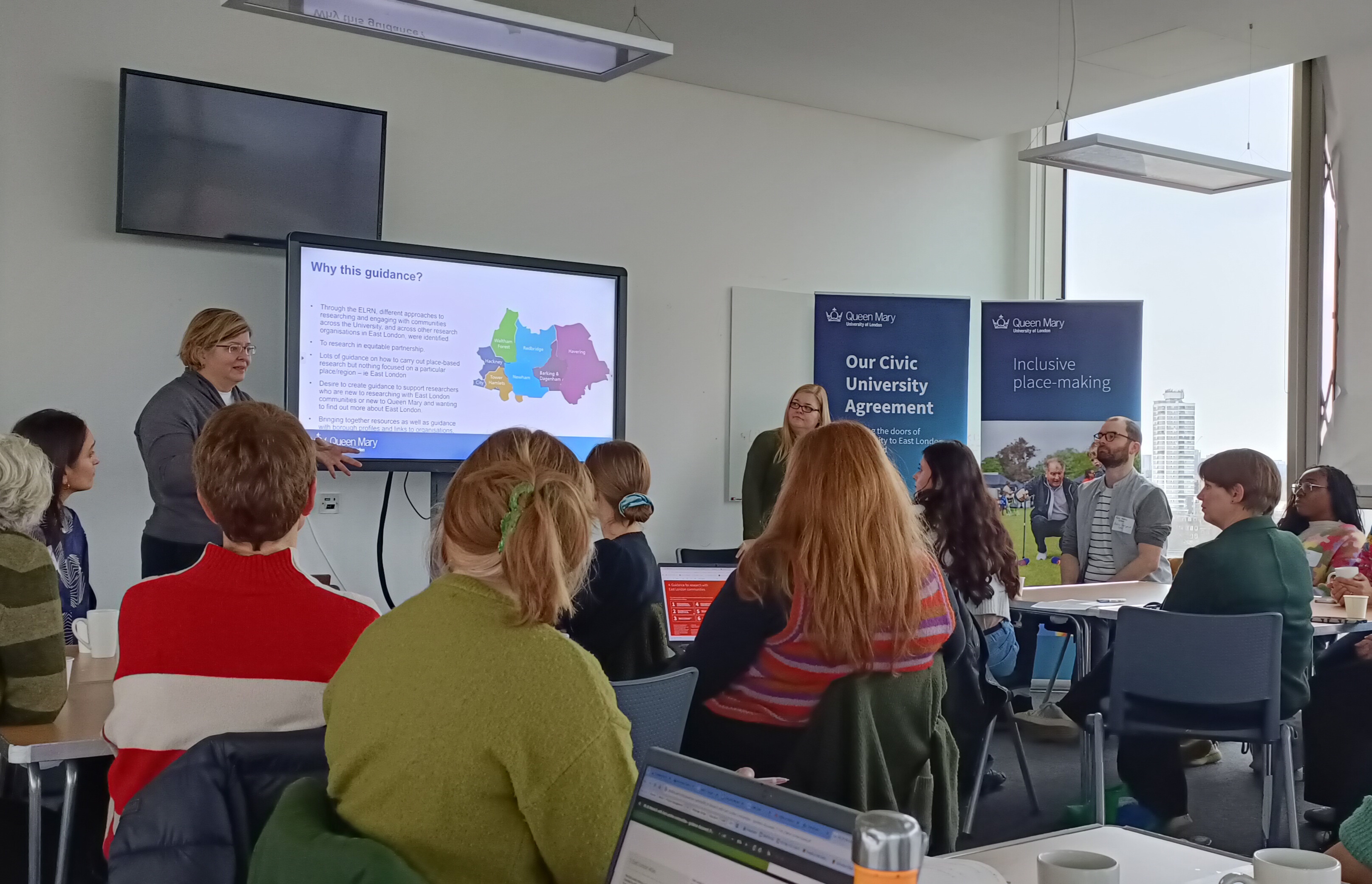 People watch a presentation about East London