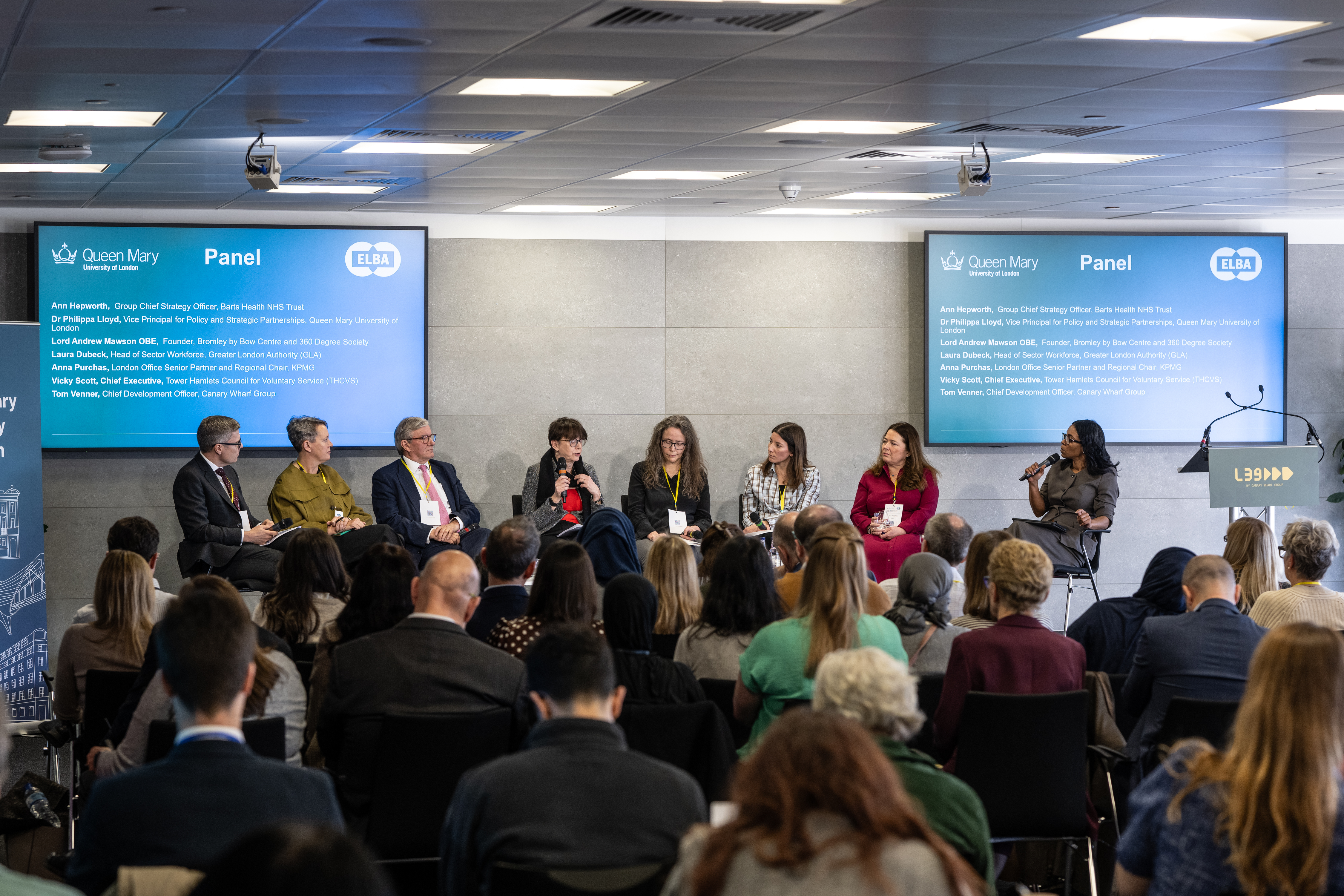 A group of people sitting on a stage