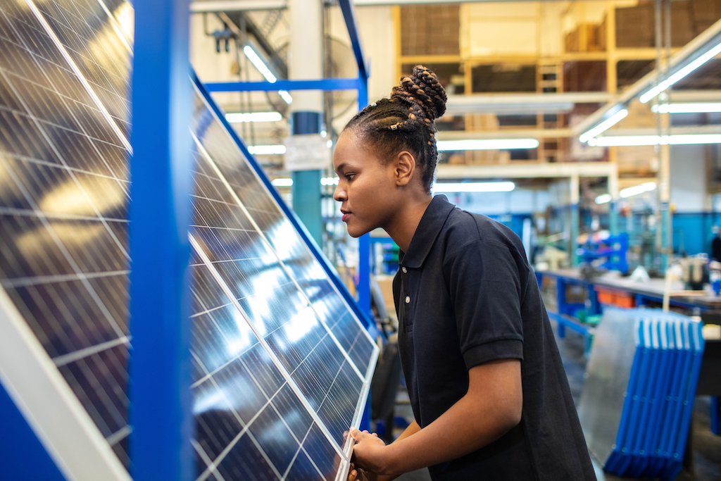Woman building a solar panel