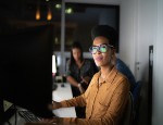 A stock photograph of a woman working in tech