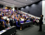Photograph of comedian Nish Kumar delivering a performance at Queen Mary