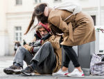 A woman offers help to a homeless man