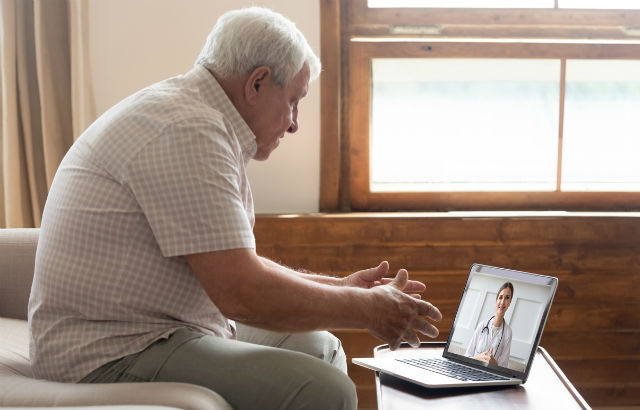 Elderly man receiving assistance during isolation