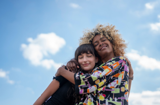 Two people share a warm hug