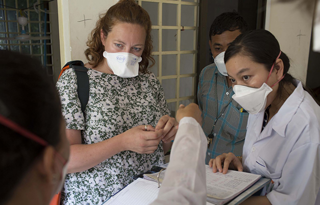Dr Jess Potter examines a patient's record on an MDR-TB ward in Phnom Penh, Cambodia. Credit: Tom Maguire/RESULTS UK