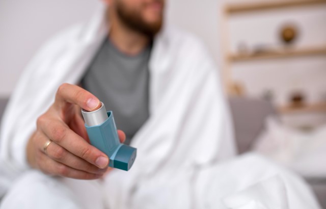 Young adult holds inhaler
