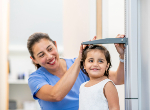 Image of child being measured. Credit: iStock.com.