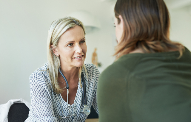 General practitioner reassuring a patient. Credit: iStock.com/AJ_WATT