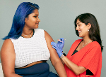 Young woman about to receive a vaccine