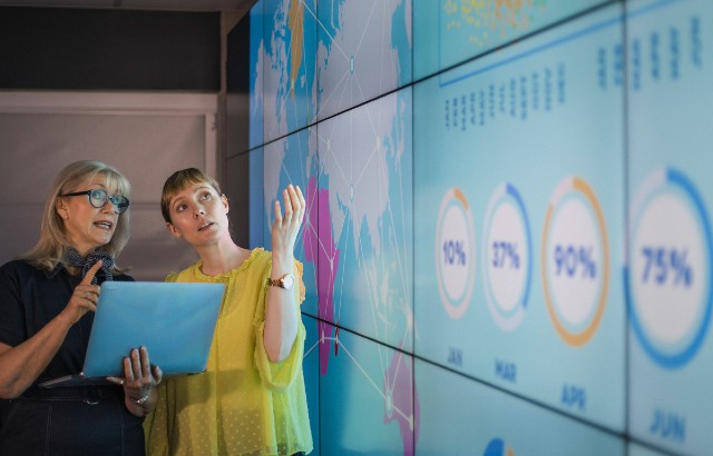 Researchers look at interactive display. Credit: SolStock/iStock.com