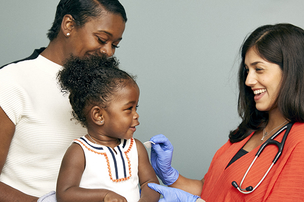 Child about to receive a vaccine from a doctor. Photo credit Flickr