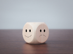 Happy and sad symbols on wooden blocks. Credit:Chaiwiwat Duangjinda/iStock.com