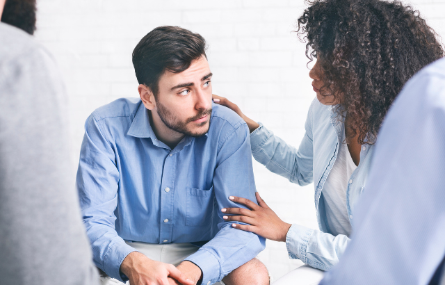 A woman reassures a man