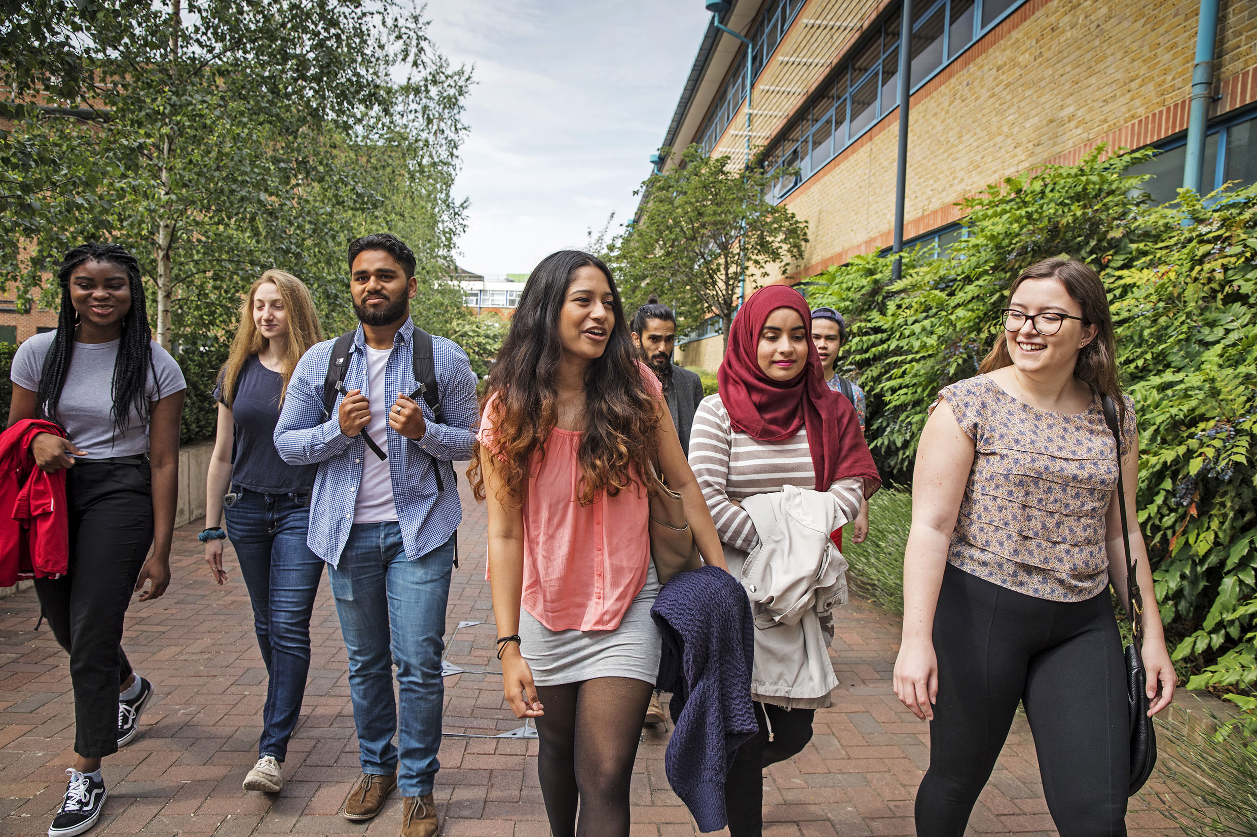 A group of students walking through campus