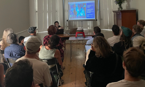 A room of people at SLBI listening to a talk