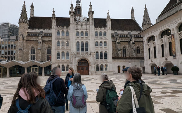 Attendees on the Legends of London walking tour standing outside the Guildhall in London