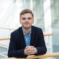 A picture of Mark Williams facing the camera wearing a suit