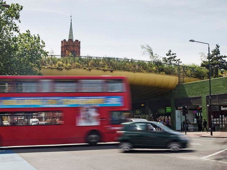 A photo of a bus and car crossing the Mile End intersection