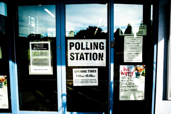 A photo of a door with a 'polling station' sign on it.