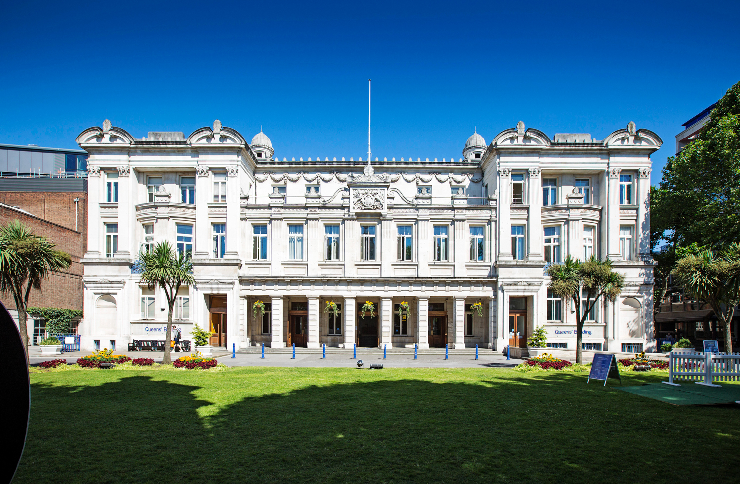 A photo of the Queen's Building, Queen Mary University of London, on a bright sunny day.