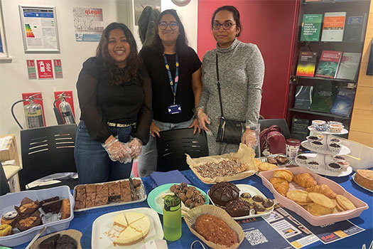 qLegal students in front of their cake staff for the Legal Bake 2023