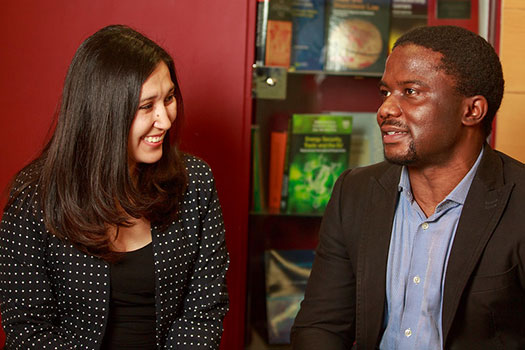 Two students sat together at the Centre for Commercial Law Studies