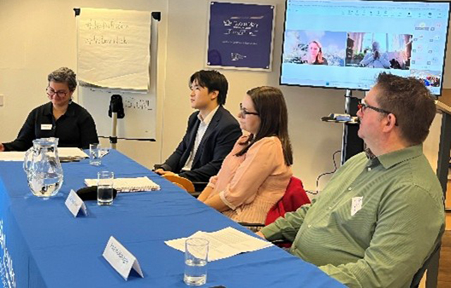 Panelists sat at the front of a seminar room.