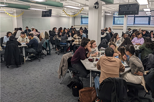 Tables of students at the qLegal Bootcamp 2022 having discussions