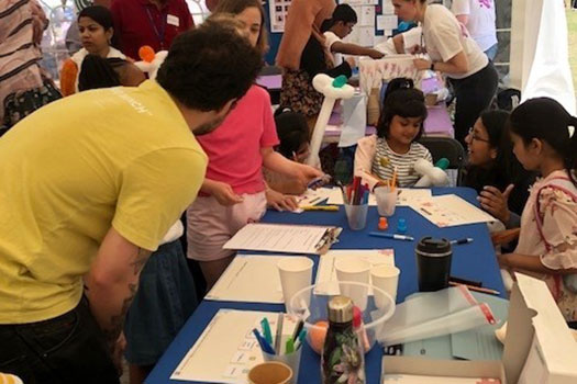 Children doing activities with qLegal at the Queen Mary Festival of Communities 2022