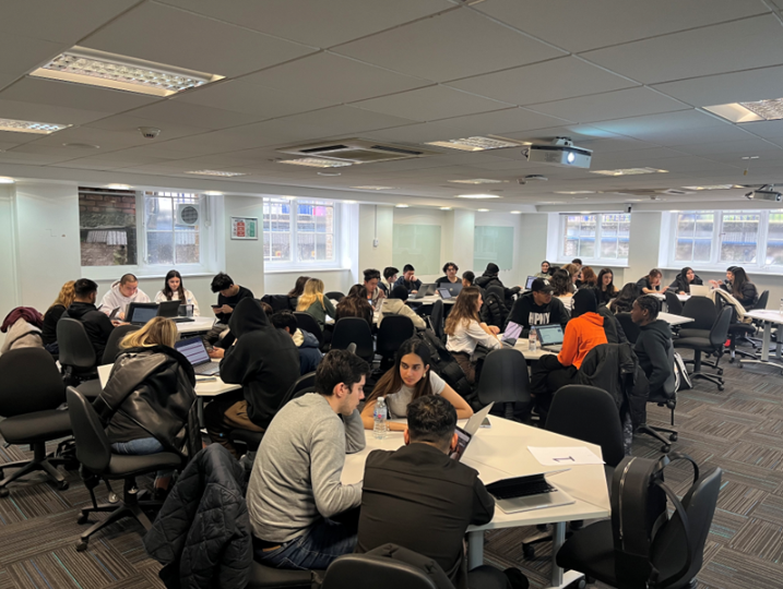 Students working and sitting at tables