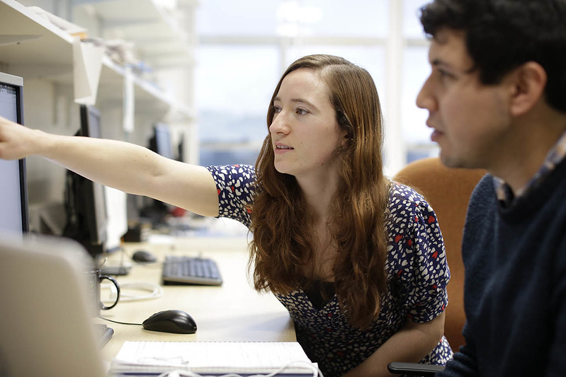 Two people looking at a computer screen