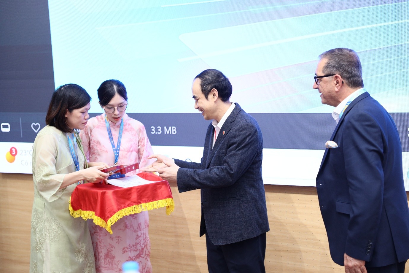 A photograph showing the presentation of an appreciation award following the invited teaching sessions delivered to Vietnamese dental universities.